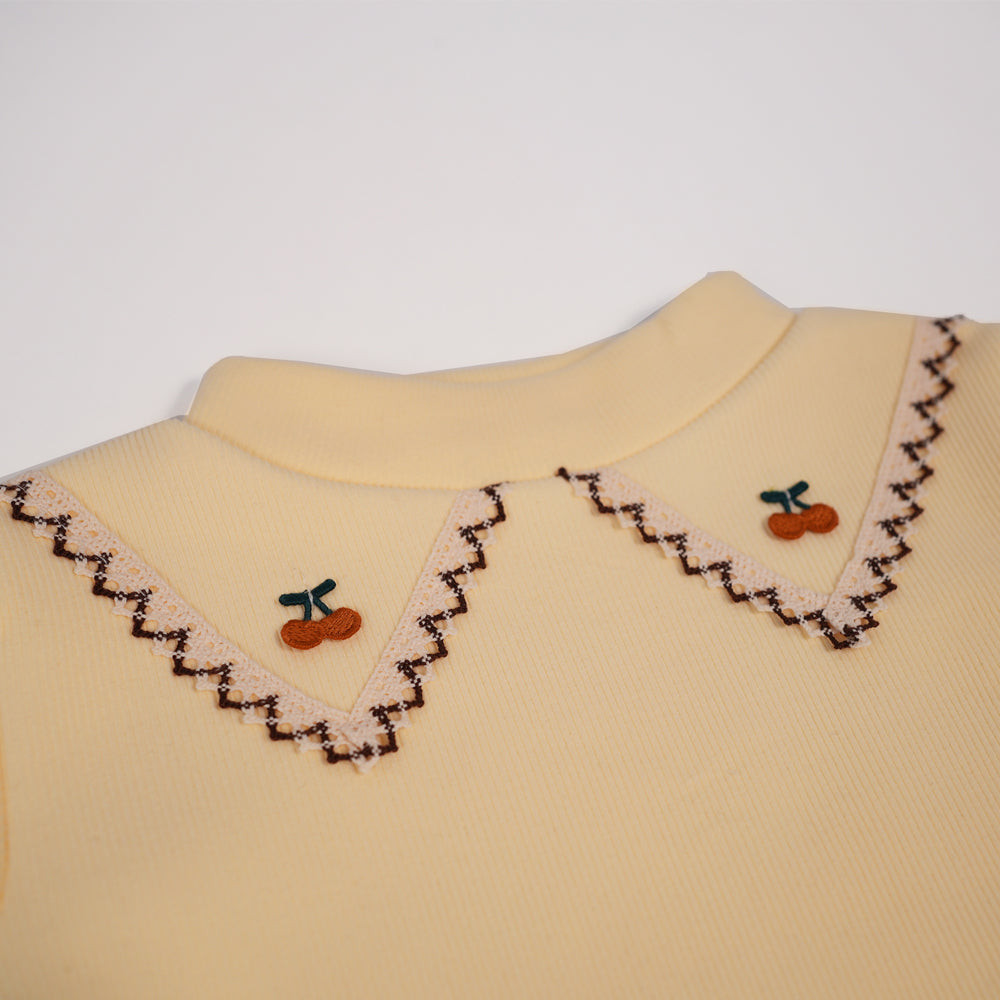 Butter yellow tee with embroidered collar motif