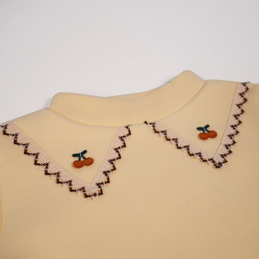 Butter yellow tee with embroidered collar motif