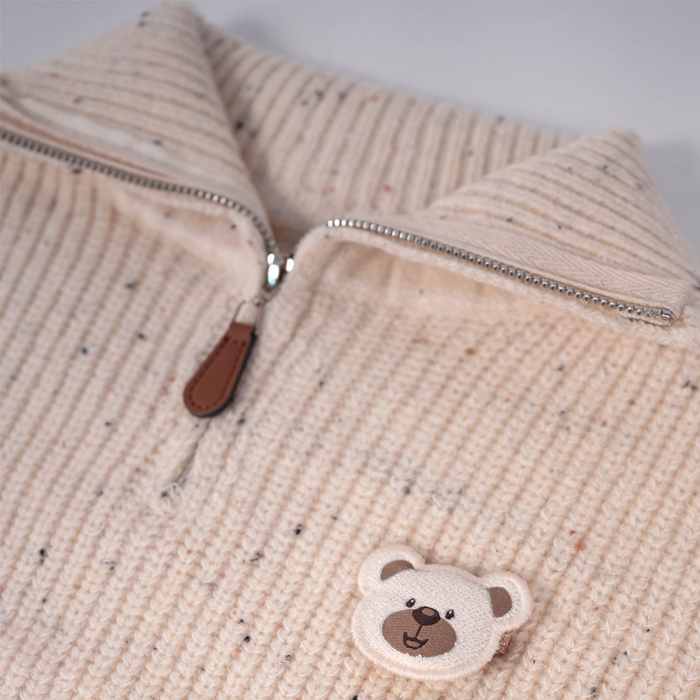 Cream zip-up knit sweater with bear brooche