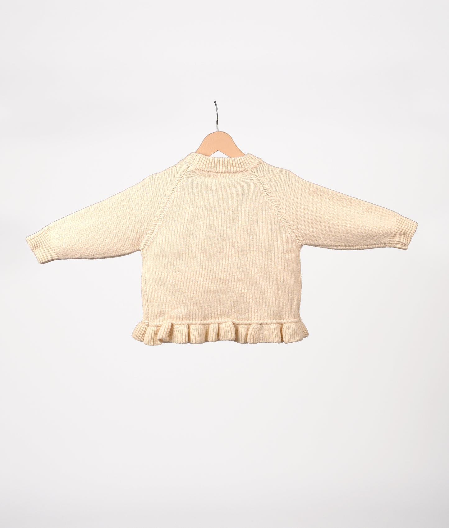 White knit sweater with bow details and frill hem