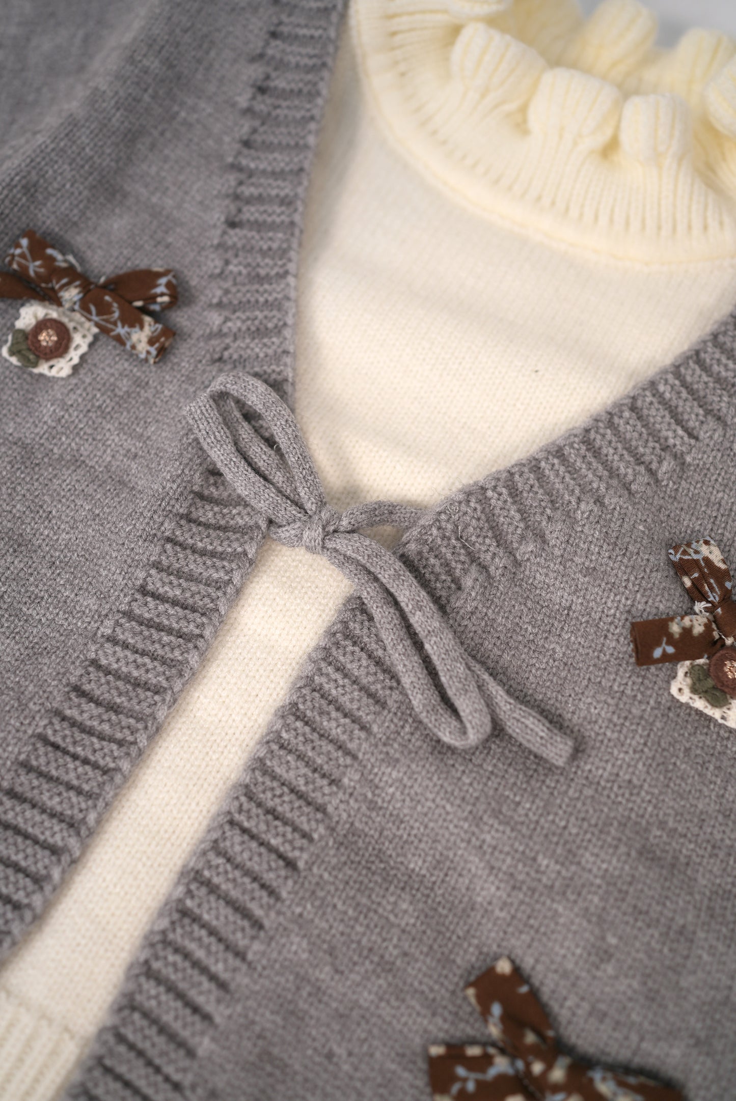 Grey knit cardigan set with cream inner top
